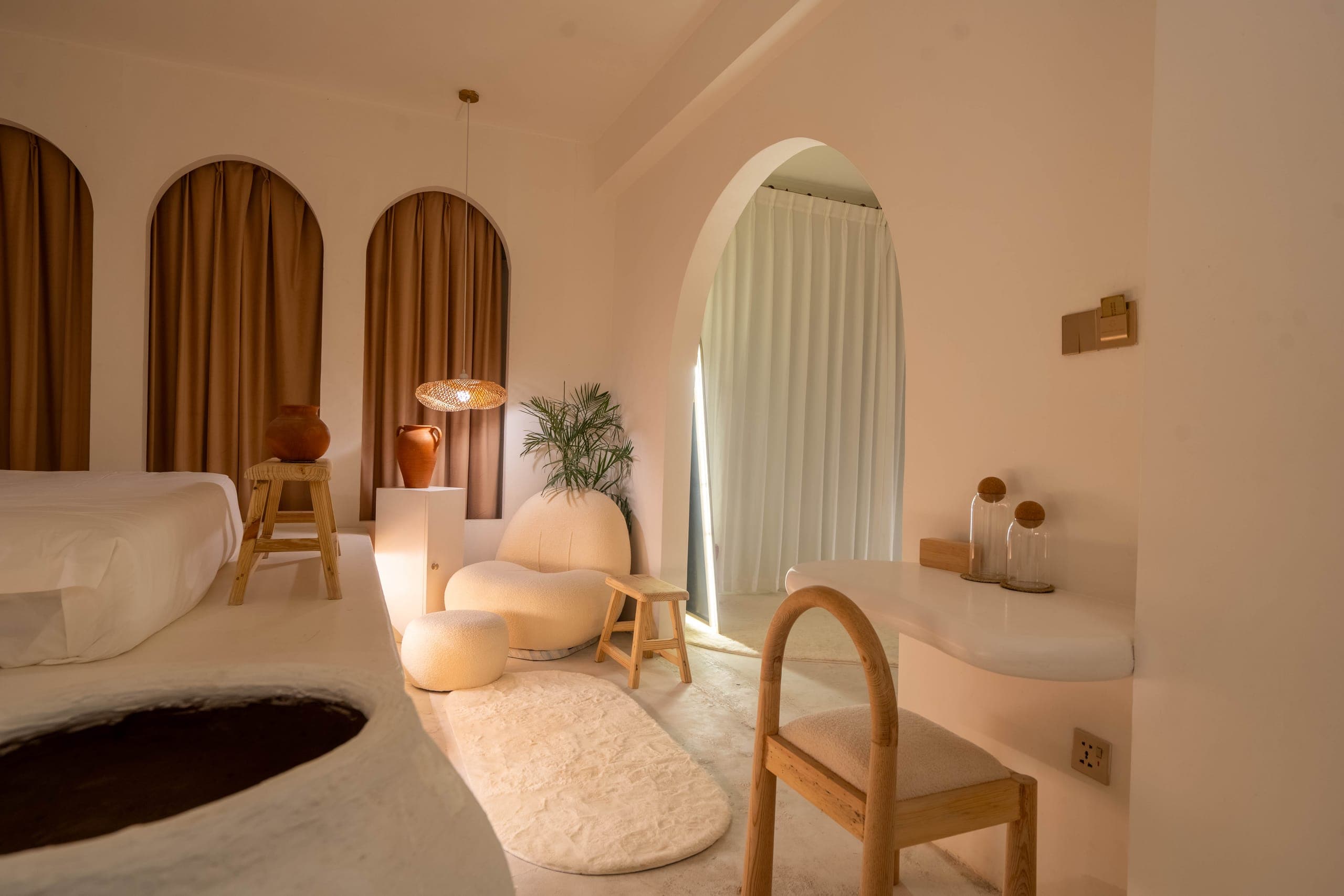 Presidential Suite lounge with three arched curtains, a sunken seat, a rug and an oak chair