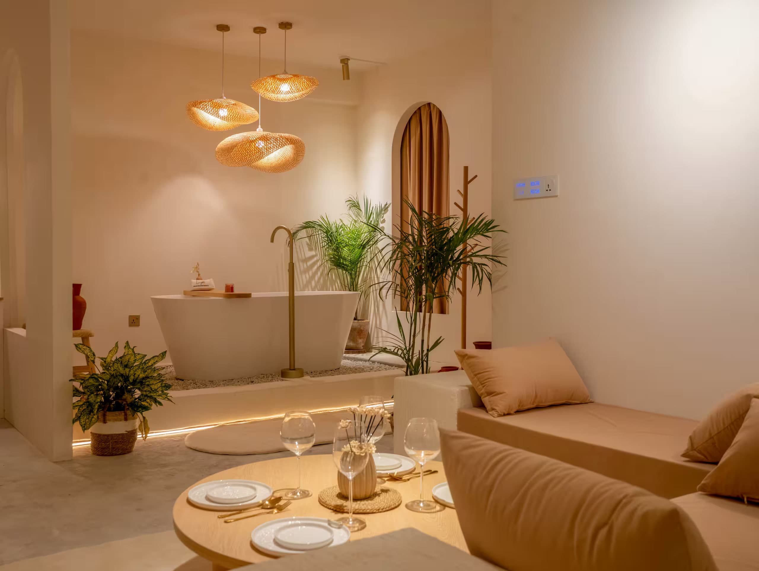 Lagom lounge and the freestanding bathtub under three bamboo pendant lights