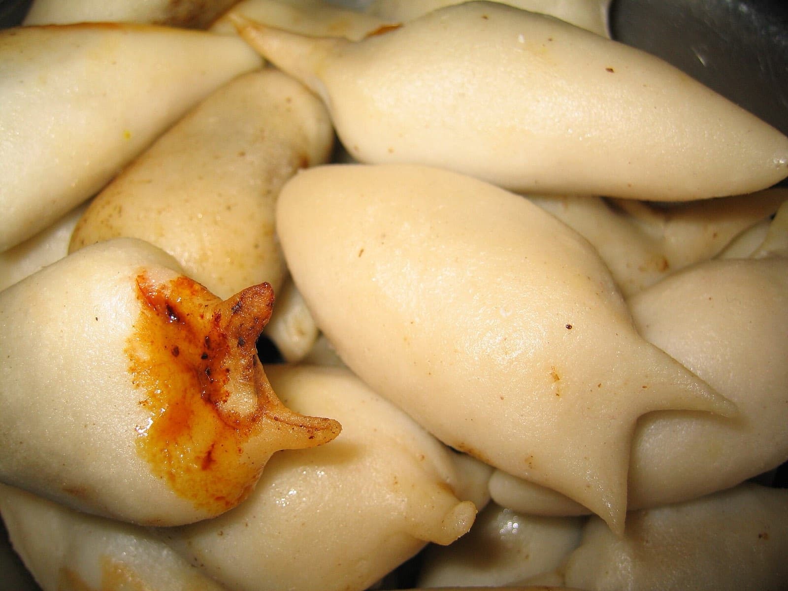 Freshly steamed yomari, fig-shaped rice-flour dumplings filled with molasses and sesame